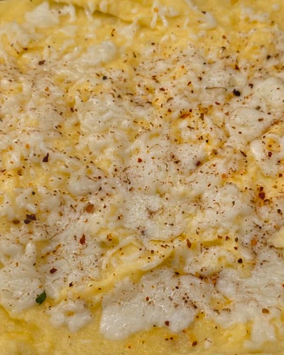 Tray of creamy polenta topped with melted cheese